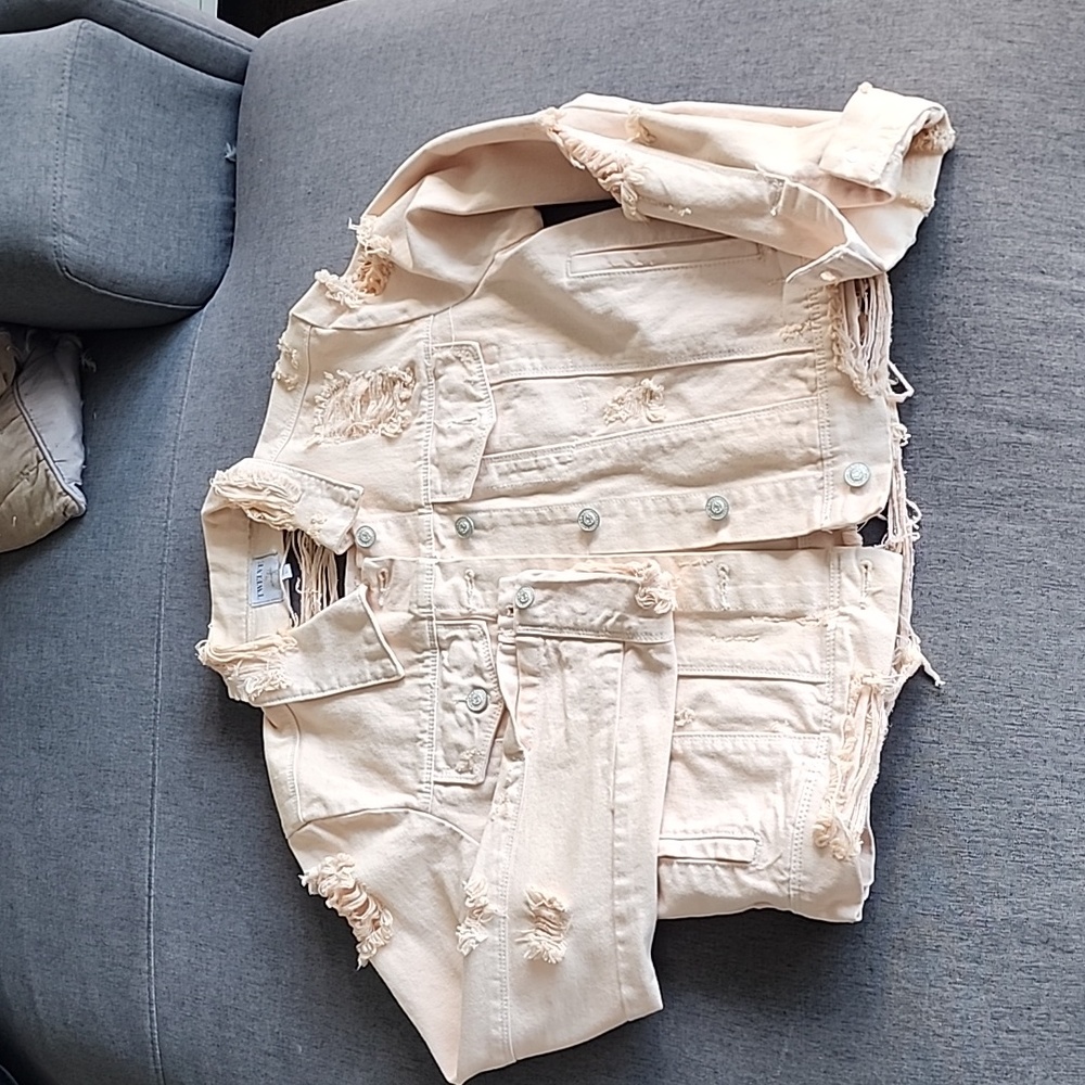 Women's fashion tattered Jean jacket light peach pink colour.